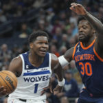 
              Minnesota Timberwolves guard Anthony Edwards (1) works toward the basket against New York Knicks forward Julius Randle (30) during the first half of an NBA basketball game, Monday, Nov. 7, 2022, in Minneapolis. (AP Photo/Abbie Parr)
            