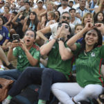 Mexico's soccer fans react as they watch their team's match against Argentina at the World Cup, hosted by Qatar, in Buenos Aires, Argentina, Saturday, Nov. 26, 2022. (AP Photo/Gustavo Garello)