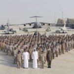 
              FILE - In this photo released by Qatar News Agency, QNA, the Qatari Emir Sheikh Tamim bin Hamad Al Thani, center front, poses for a photo with members of the Emiri Air Force at al-Udeid Air Base in Doha, Qatar, Sept. 11, 2017. Qatar will be on the world stage like it never has before as the small, energy-rich nations hosts the 2022 FIFA World Cup beginning this November. (QNA via AP, File)
            