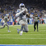 
              Detroit Lions running back D'Andre Swift runs into the end zone for a two-point conversion during the second half of an NFL football game against the Buffalo Bills, Thursday, Nov. 24, 2022, in Detroit. (AP Photo/Paul Sancya)
            