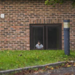 
              A boy thought to be a migrant looks out of the Manston immigration short-term holding facility near Thanet, Kent, England, Wednesday, Nov. 2, 2022. (AP Photo Alberto Pezzali)
            