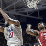 
              South Alabama center Kevin Samuel (21) rebounds the ball away from Alabama forward Nick Pringle (23) during the first half of an NCAA college basketball game, Tuesday, Nov. 15, 2022, in Mobile, Ala. (AP Photo/Vasha Hunt)
            