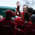 Canada's Denis Shapovalov, top center, celebrates with teammate after defeating Australia's Thanasi Kokkinakis during the final Davis Cup tennis match between Australia and Canada in Malaga, Spain, Sunday, Nov. 27, 2022. (AP Photo/Joan Monfort)