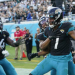 
              Jacksonville Jaguars wide receiver Zay Jones (7) celebrates a two-point conversion catch with his team during the second half of an NFL football game against the Baltimore Ravens, Sunday, Nov. 27, 2022, in Jacksonville, Fla. (AP Photo/John Raoux)
            