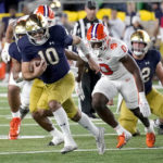 Notre Dame quarterback Drew Pyne carries the ball as Clemson linebacker Barrett Carter pursues during the first half of an NCAA college football game Saturday, Nov. 5, 2022, in South Bend, Ind. (AP Photo/Charles Rex Arbogast)