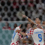Croatia players celebrate after teammate Marko Livaja scored their side's second goal during the World Cup group F soccer match between Croatia and Canada, at the Khalifa International Stadium in Doha, Qatar, Sunday, Nov. 27, 2022. (AP Photo/Martin Meissner)