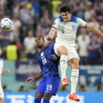 England's Harry Maguire, right, vies for the ball with Haji Wright of the United States during the World Cup group B soccer match between England and The United States, at the Al Bayt Stadium in Al Khor , Qatar, Friday, Nov. 25, 2022. (AP Photo/Luca Bruno)