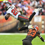 Tampa Bay Buccaneers running back Rachaad White (29) is upended by Cleveland Browns cornerback Martin Emerson Jr. (23) during the second half of an NFL football game in Cleveland, Sunday, Nov. 27, 2022. (AP Photo/David Richard)