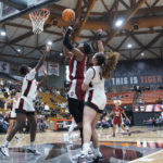 
              Stanford forward Francesca Belibi, middle, shoots the ball between Pacific guard Anaya James, left, and center Elizabeth Elliott, right, during the second half of an NCAA college basketball game in Stockton, Calif., Friday, Nov. 11, 2022. (AP Photo/Godofredo A. Vásquez)
            