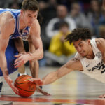 
              Duke's Kyle Filipowski, left, and Xavier guard Colby Jones (3) battle for the ball during the second half of an NCAA college basketball game in the Phil Knight Legacy tournament Friday, Nov. 25, 2022, in Portland, Ore. (AP Photo/Rick Bowmer)
            