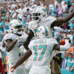 Miami Dolphins wide receiver Tyreek Hill (10), center, is congratulated by his teammates after scoring a touchdown during the second half of an NFL football game against the Cleveland Browns, Sunday, Nov. 13, 2022, in Miami Gardens, Fla. (AP Photo/Wilfredo Lee )