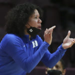 FILE - Duke head coach Kara Lawson gives instructions to her team during the first half of an NCAA college basketball game against Virginia Tech, Thursday, Dec. 30, 2021 in Blacksburg Va.  The Atlantic Coast and Southeastern conferences have led the way among the power conferences in hiring coaches of color to lead women's basketball programs. (Matt Gentry/The Roanoke Times via AP, File)