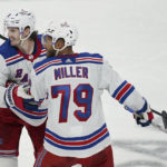 New York Rangers defenseman Jacob Trouba, left, celebrates with defenseman K'Andre Miller (79) after a goal by  Julien Gauthier during the third period of the team's NHL hockey game against the San Jose Sharks in San Jose, Calif., Saturday, Nov. 19, 2022. (AP Photo/Jeff Chiu)