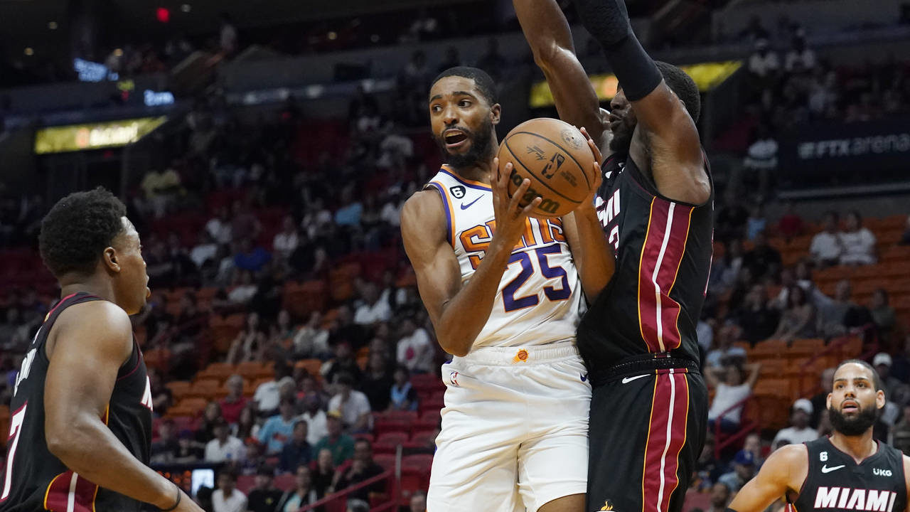 Phoenix Suns forward Mikal Bridges (25) looks to pass the ball as Miami Heat center Bam Adebayo (13...