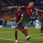 
              Portugal's Cristiano Ronaldo celebrates after scoring from the penalty spot his side's opening goal against Ghana during a World Cup group H soccer match at the Stadium 974 in Doha, Qatar, Thursday, Nov. 24, 2022. (AP Photo/Manu Fernandez)
            