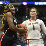Connecticut's Aaliyah Edwards drives to the basket as NC State's River Baldwin (1) defends during the first half of an NCAA college basketball game, Sunday, Nov. 20, 2022, in Hartford, Conn. (AP Photo/Jessica Hill)