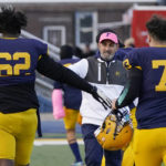 
              Dearborn Fordson High School head coach Fouad Zaban greets players before the game against Dearborn High School, Friday, Oct. 14, 2022 in Dearborn, Mich. (AP Photo/Carlos Osorio)
            
