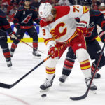 
              Calgary Flames' Tyler Toffoli (73) controls the puck in front of Carolina Hurricanes' Brent Burns (8) during the first period of an NHL hockey game in Raleigh, N.C., Saturday, Nov. 26, 2022. (AP Photo/Karl B DeBlaker)
            