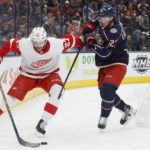
              Detroit Red Wings' Michael Rasmussen, left, keeps the puck away from Columbus Blue Jackets' Jake Christiansen during the first period of an NHL hockey game, Saturday, Nov. 19, 2022, in Columbus, Ohio. (AP Photo/Jay LaPrete)
            