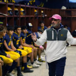 
              Dearborn Fordson High School head coach Fouad Zaban addresses the team in the locker room before the game against Dearborn High School, Friday, Oct. 14, 2022 in Dearborn, Mich. Across America, most high school football seasons are winding down. It will wrap up the first year since the Supreme Court ruled it was OK for a public school coach near Seattle to pray on the field. After the court ruling, Zaban said he was flooded with requests to use his platform and constitutional right to pray publicly. After thinking about it, he chose to keep his team's prayers behind closed doors to avoid potential anti-Islamic jeers from fans in other communities. (AP Photo/Carlos Osorio)
            