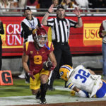 An official signals a touchdown by Southern California wide receiver Michael Jackson III (9) against California's Myles Jernigan during the first half of an NCAA college football game Saturday, Nov. 5, 2022, in Los Angeles. (AP Photo/John McCoy)