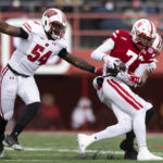 
              Nebraska's Marcus Washington, center, catches an 11-yard pass against Wisconsin's Jordan Turner, left, and Justin Clark during the first half of an NCAA college football game Saturday, Nov. 19, 2022, in Lincoln, Neb. (AP Photo/Rebecca S. Gratz)
            