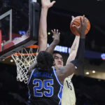 
              Purdue center Zach Edey, right, blocks a shot from Duke forward Mark Mitchell during the first half of an NCAA college basketball game in the Phil Knight Legacy Championship in Portland, Ore., Sunday, Nov. 27, 2022. (AP Photo/Craig Mitchelldyer)
            