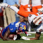 
              Kansas cornerback Ra'Mello Dotson (3) is tackled by Oklahoma State wide receiver Rashod Owens (10) after intercepting a pass during the first half of an NCAA college football game Saturday, Nov. 5, 2022, in Lawrence, Kan. (AP Photo/Charlie Riedel)
            