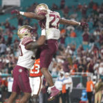 
              Florida State running back CJ Campbell (22) is lifted into the air by tight end DJ Daniels after scoring a touchdown during the second half of an NCAA college football game against Miami, Saturday, Nov. 5, 2022, in Miami Gardens, Fla.(AP Photo/Lynne Sladky)
            