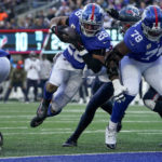 New York Giants running back Saquon Barkley (26) crosses the goal line for a touchdown against the Houston Texans during the third quarter of an NFL football game, Sunday, Nov. 13, 2022, in East Rutherford, N.J. (AP Photo/John Minchillo)
