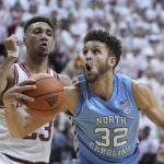 
              CORRECTS CITY TO BLOOMINGTON, INSTEAD OF INDIANAPOLIS - North Carolina forward Pete Nance (32) drives to the basket against Indiana forward Trayce Jackson-Davis (23) during the first half of an NCAA college basketball game in Bloomington, Ind., , Wednesday, Nov. 30, 2022. (AP Photo/Darron Cummings)
            