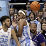 
              North Carolina forward Pete Nance (32) and forward Armando Bacot, center, and James Madison guard Takal Molson, right, all keep their eyes on a loose ball during the first half of an NCAA college basketball game Sunday, Nov. 20, 2022, in Chapel Hill, N.C. (AP Photo/Chris Seward)
            
