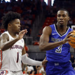 
              Saint Louis guard Javonte Perkins (3) drives to the basket around Auburn guard Wendell Green Jr. (1) during the first half of an NCAA college basketball game Sunday, Nov. 27, 2022, in Auburn, Ala. (AP Photo/Butch Dill)
            