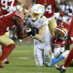 Los Angeles Chargers quarterback Justin Herbert (10) is hit by San Francisco 49ers linebacker Dre Greenlaw, left, and cornerback Jimmie Ward (1) during the first half of an NFL football game in Santa Clara, Calif., Sunday, Nov. 13, 2022. Greenlaw was disqualified after the play. (AP Photo/Jed Jacobsohn)
