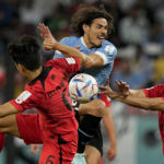 
              Uruguay's Edinson Cavani, center, fights for the ball with South Korea's Hwang In-beom, left, and Jung Woo-young during the World Cup group H soccer match between Uruguay and South Korea, at the Education City Stadium in Al Rayyan , Qatar, Thursday, Nov. 24, 2022. (AP Photo/Martin Meissner)
            