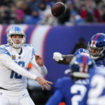 Detroit Lions quarterback Jared Goff (16) passes under pressure from New York Giants defensive tackle Dexter Lawrence (97) during the second half of an NFL football game, Sunday, Nov. 20, 2022, in East Rutherford, N.J. (AP Photo/Seth Wenig)