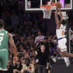 
              New York Knicks guard Immanuel Quickley (5) dunks as Boston Celtics guard Jaylen Brown (7) watches during the first half of an NBA basketball game Saturday, Nov. 5, 2022, at Madison Square Garden in New York. (AP Photo/Jessie Alcheh)
            