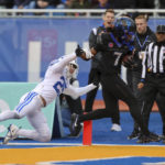 Boise State wide receiver Latrell Caples (7) crosses the goal line for a touchdown as BYU defensive back Talan Alfrey (25) tries to knock him out of bounds in the first half of an NCAA college football game, Saturday, Nov. 5, 2022, in Boise, Idaho. (AP Photo/Steve Conner)