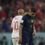 
              France's Kylian Mbappe, right, and Tunisia's Wahbi Khazri leave after the World Cup group D soccer match between Tunisia and France at the Education City Stadium in Al Rayyan , Qatar, Wednesday, Nov. 30, 2022. Defending champion France won its World Cup group despite losing to Tunisia 1-0. (AP Photo/Christophe Ena)
            