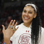 
              South Carolina center Kamilla Cardoso shows off her rings as the 2022 South Carolina national championship team receive their rings before an an NCAA college basketball game in Columbia, S.C., Monday, Nov. 7, 2022. (AP Photo/Nell Redmond)
            