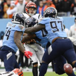 
              Cincinnati Bengals quarterback Joe Burrow (9) his hit by the Tennessee Titans defense during the second half of an NFL football game, Sunday, Nov. 27, 2022, in Nashville, Tenn. Burrow was called for intentional grounding on the play. (AP Photo/Mark Zaleski)
            