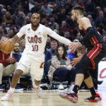 
              Cleveland Cavaliers guard Darius Garland (10) drives against Miami Heat guard Max Strus (31) during the first half of an NBA basketball game, Sunday, Nov. 20, 2022, in Cleveland. (AP Photo/Ron Schwane)
            