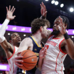 
              Northern Colorado forward Brock Wisne, center, is boxed up by Houston forwards Reggie Chaney, left, and J'Wan Roberts, right, during the first half of an NCAA college basketball game Monday, Nov. 7, 2022, in Houston. (AP Photo/Michael Wyke)
            