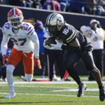 
              Vanderbilt wide receiver Jayden McGowan (16) scores a touchdown ahead of Florida safety Jadarrius Perkins (27) in the first half of an NCAA college football game Saturday, Nov. 19, 2022, in Nashville, Tenn. (AP Photo/Mark Humphrey)
            