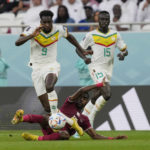 
              Senegal's Boulaye Dia is tackled by Qatar's Ismail Mohamad during the World Cup group A soccer match between Qatar and Senegal, at the Al Thumama Stadium in Doha, Qatar, Friday, Nov. 25, 2022. (AP Photo/Thanassis Stavrakis)
            