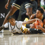 
              Virginia Commonwealth guard Nick Kern (24) tries to steal the ball from Vanderbilt guard Jordan Wright (4) during the first half of an NCAA college basketball game, Wednesday, Nov. 30, 2022 at Seigel Center in Richmond, Va. (Shaban Athuman/Richmond Times-Dispatch via AP)
            