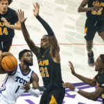 TCU guard Mike Miles Jr. (1) attempts to get around Arkansas-Pine Bluff guard Shaun Doss Jr. (21) in the first half of an NCAA college basketball game in Fort Worth, Texas, Monday, Nov. 7, 2022. (AP Photo/Emil Lippe)