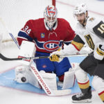 Vegas Golden Knights' Nicolas Roy and Montreal Canadiens goaltender Jake Allen watch the puck during the second period of an NHL hockey game Saturday, Nov. 5, 2022, in Montreal. (Graham Hughes/The Canadian Press via AP)