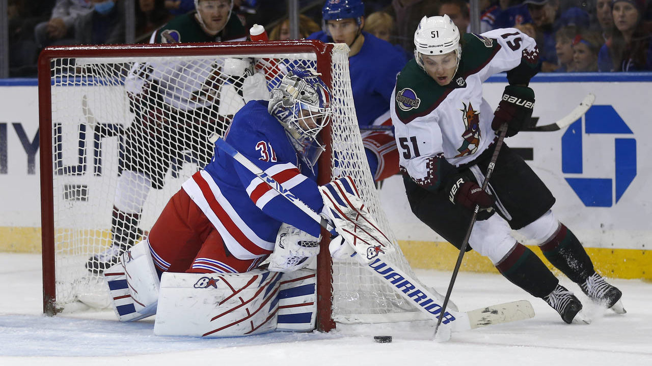 New York Rangers goalie Igor Shesterkin defends against a wraparound-attempt by Arizona Coyotes def...