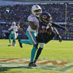 
              Chicago Bears wide receiver Darnell Mooney (11) scores against Miami Dolphins cornerback Xavien Howard (25) during the first half of an NFL football game, Sunday, Nov. 6, 2022 in Chicago. (AP Photo/Nam Y. Huh)
            
